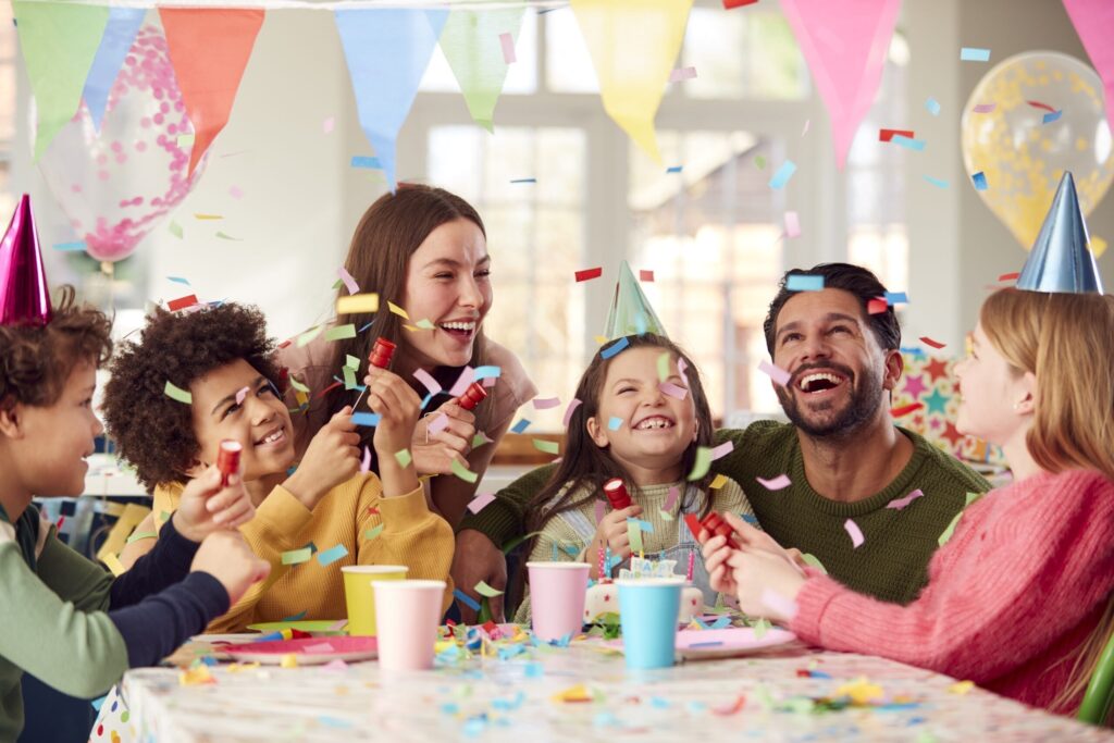 girl with parents friends home celebrating birthday firing confetti poppers party scaled 1 1 Inventory
